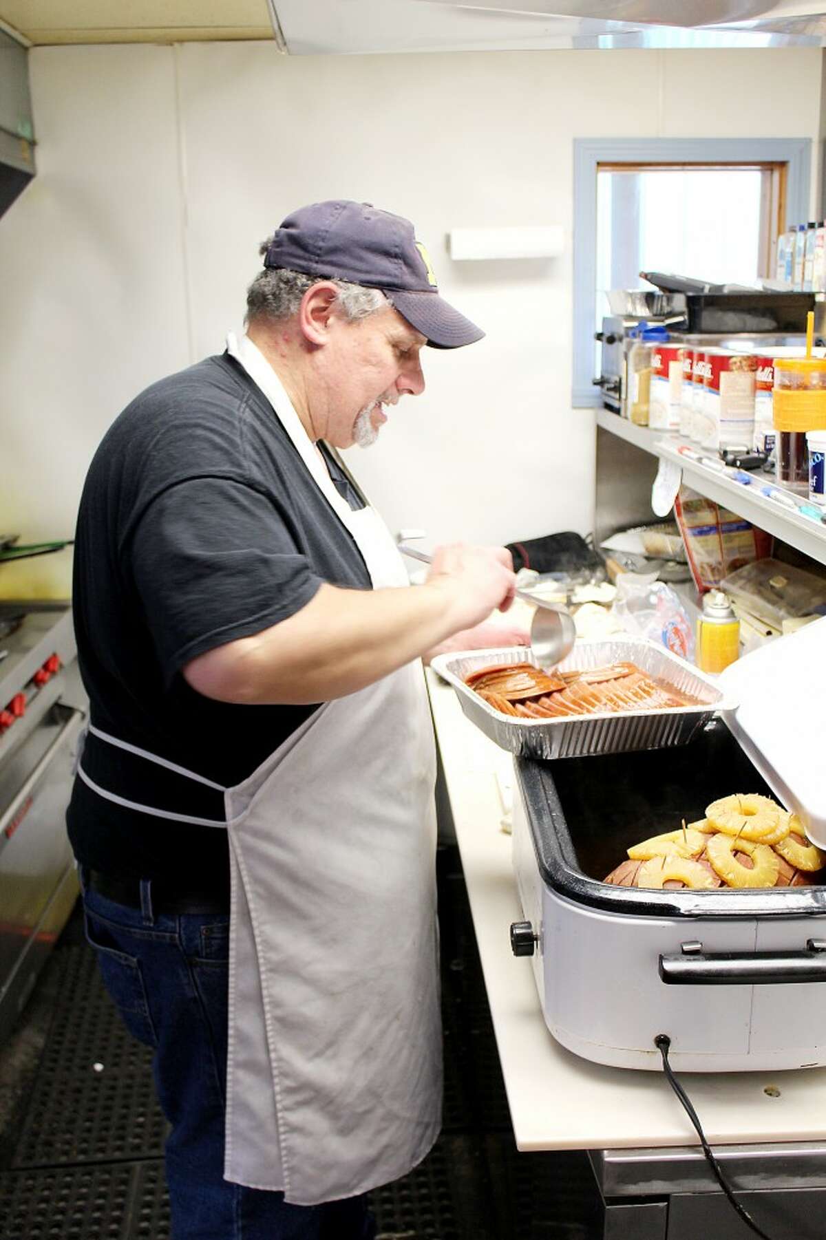 COMMUNITY OUTREACH: Richard Pemberton hosts a free Thanksgiving dinner at Nestle Inn Cafe in Reed City, with his partner, Shari Holben. (Pioneer file photo)
