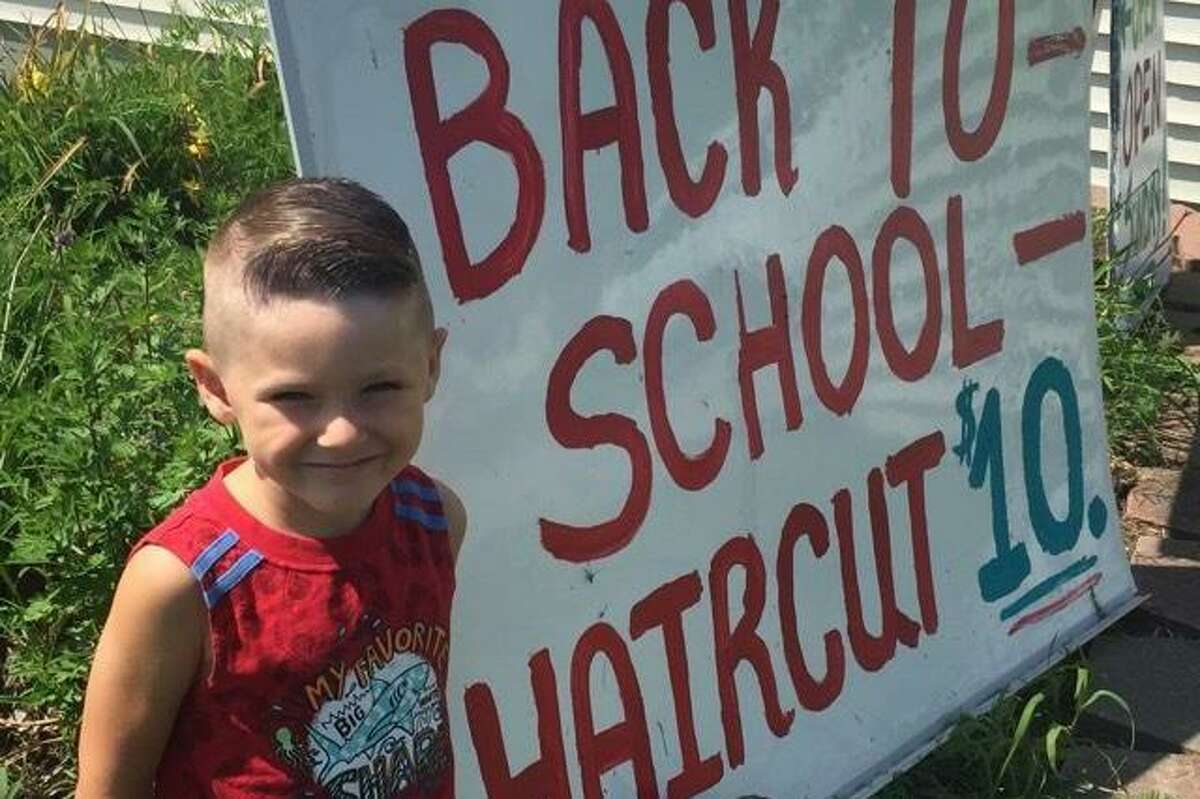 Hair Dr. in Torrington, located at 1049 East Main St., encouraged children to come in for a $10 haircut to return to school. Brayden showed off his new “do” outside the salon.