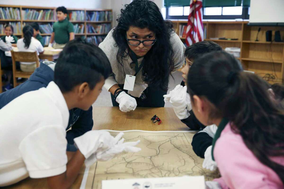 Fourth grade teacher Jennifer Cruz engages her students during a Texas history lesson at Storm Relay Lab Elementary School on Monday. Texas Land Commissioner George P. Bush gave a lesson to two fourth grade classes at the school and later visited Hillcrest Elementary, bringing copies of an 1887 Texas railroad system map and a Mexican Army cannonball that is thought to date back to the Battle of the Alamo.