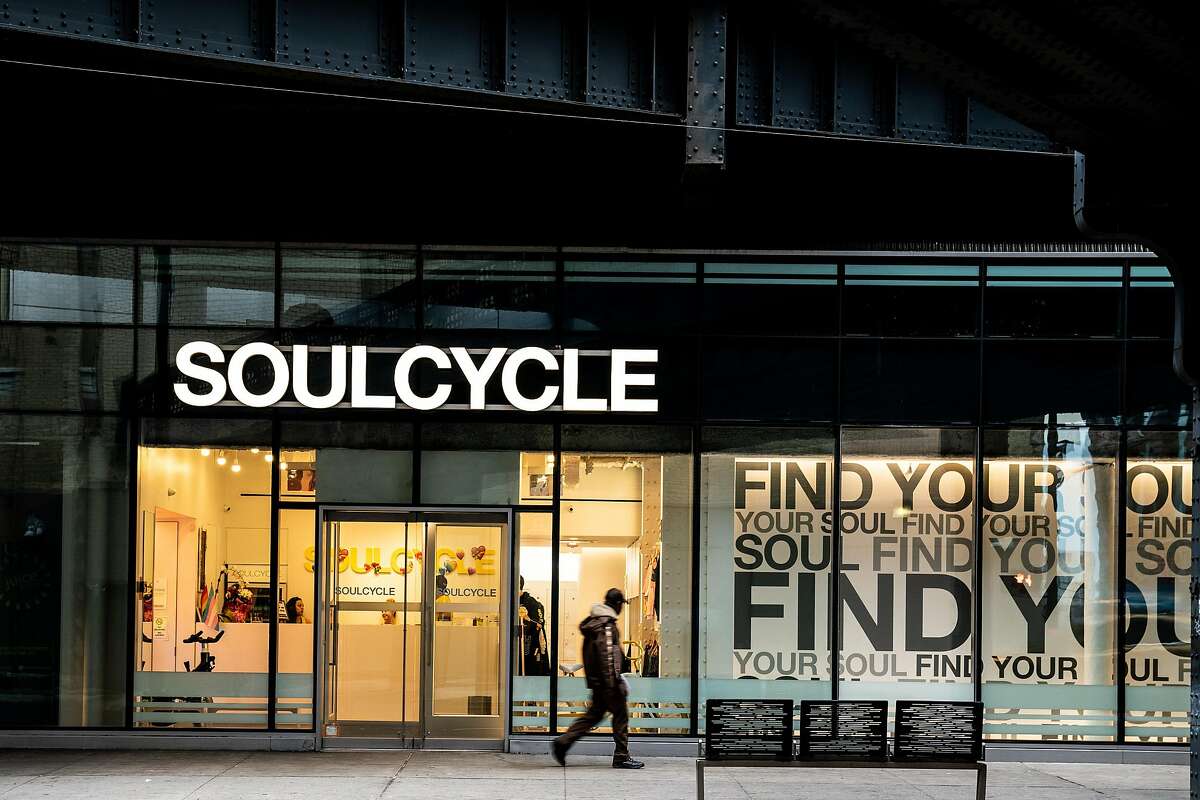 FILE -- A pedestrian walks past SoulCycle in Manhattan, Feb. 15, 2019. In the Trump era, a number of companies have found themselves, willingly or not, tossed by partisan storms. (Jeenah Moon/The New York Times)