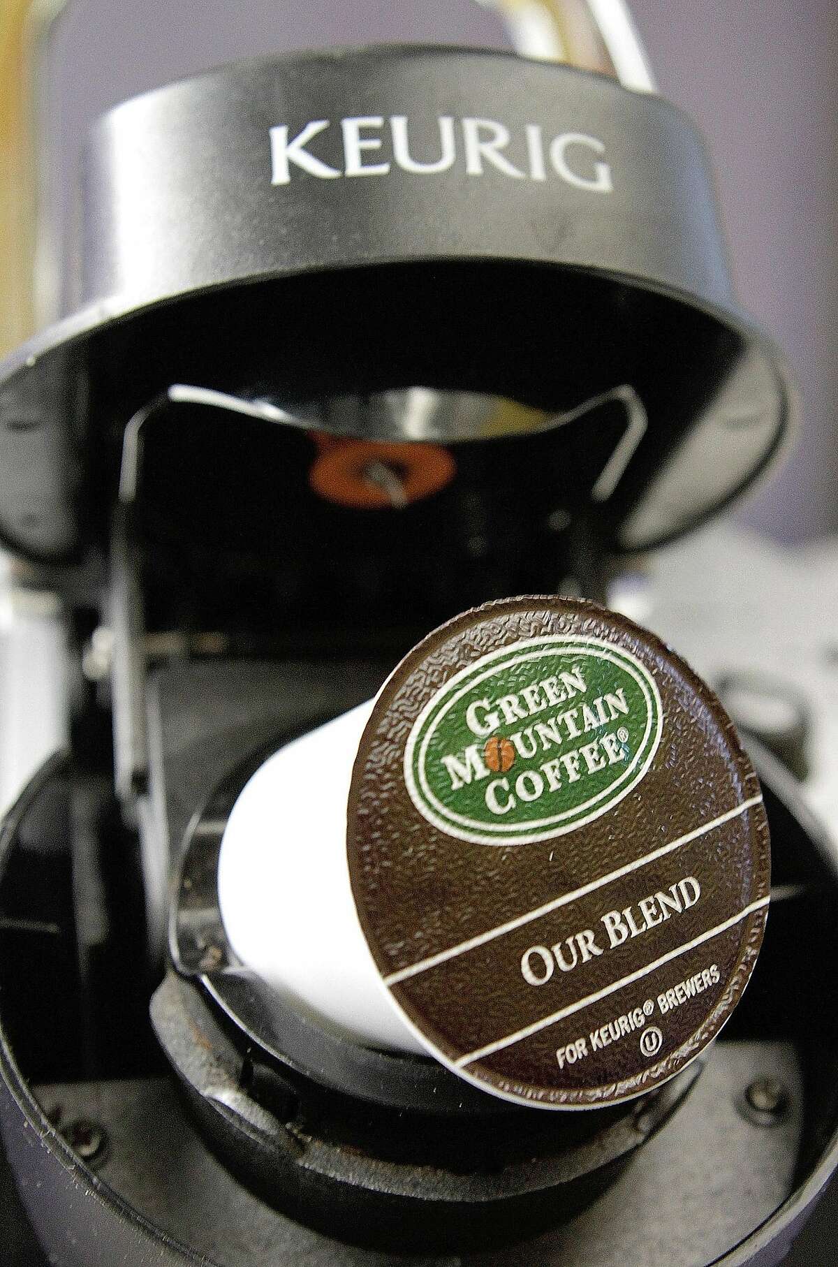 FILE - In this Oct. 7, 2010, file photo, a Green Mountain Coffee single-serving brewing cup is seen in a Keurig machine in Montpelier, Vt. Keurig, the single-cup coffee machine maker, said Monday, Dec. 7, 2015, that it has agreed to be sold to private equity firm JAB Holding Co. for almost $14 billion. (AP Photo/Toby Talbot, File)