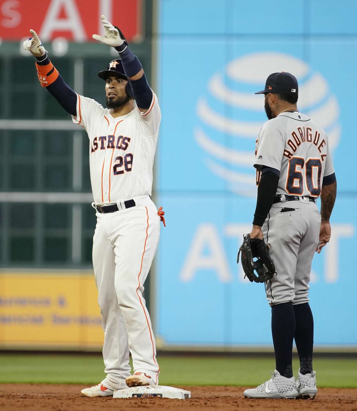 Houston Astros Robinson Chirinos raises his hands as he stands at second base with Detroit Tigers Ronny Rodriguez during the first inning of MLB game at Minute Maid Park Monday, Aug. 19, 2019, in Houston. Robinson Chirinos got to second base on a fielding error by left fielder Brandon Dixon.