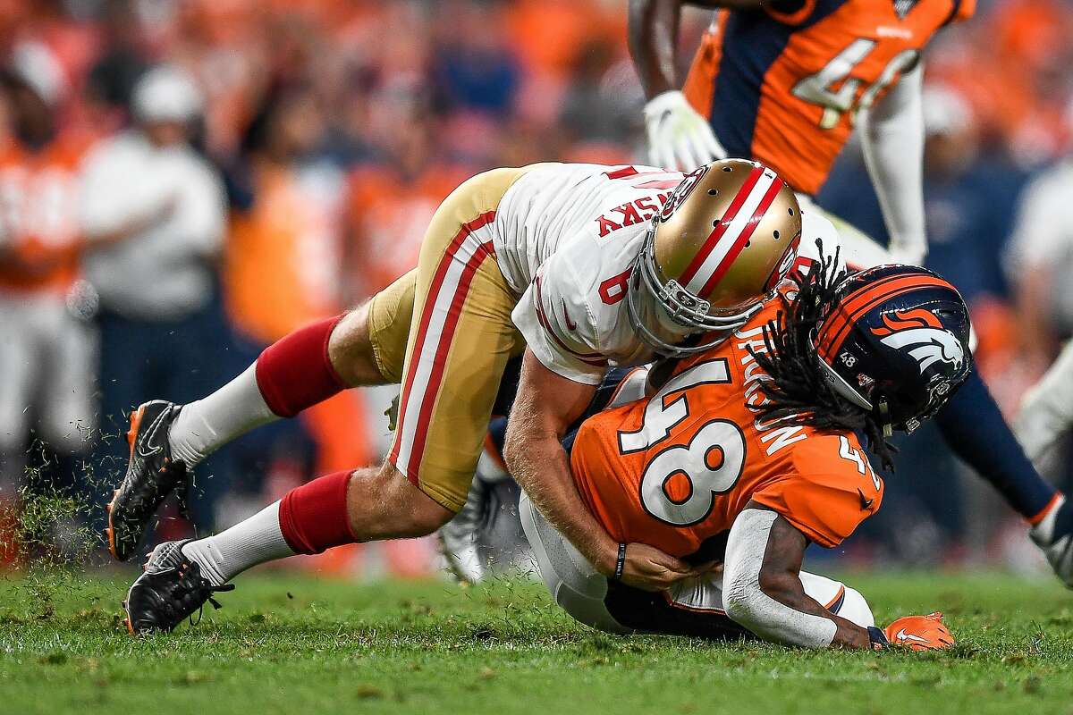 Punter Mitch Wishnowsky of the San Francisco 49ers hits and tackles running back Devontae Jackson of the Denver Broncos on a punt return in the third quarter during a preseason National Football League game at Broncos Stadium at Mile High on August 19, 2019 in Denver, Colorado. EA Sports raised the tackle rating in the video game Madden '20 for  Wishnowsky after he landed a devastating hit on Denver Broncos returner Devontae Jackson during the Monday Night Football game between the Niners and Broncos.