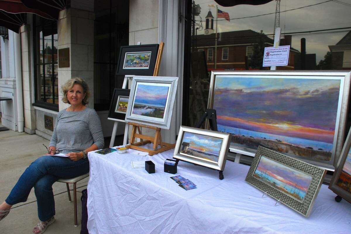 The Art Society of Old Greenwich will be hosting its 68th annual Sidewalk Art Show & Sale September 14-15. Gail Bell with her landscapes at last year’s event.