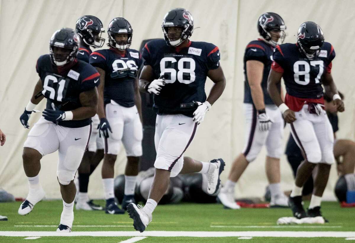 Houston Texans offensive guards Maurquice Shakir (61) and Malcolm Pridgeon (68) run a drill during training camp at the Methodist Training Center on Tuesday, Aug. 20, 2019, in Houston.