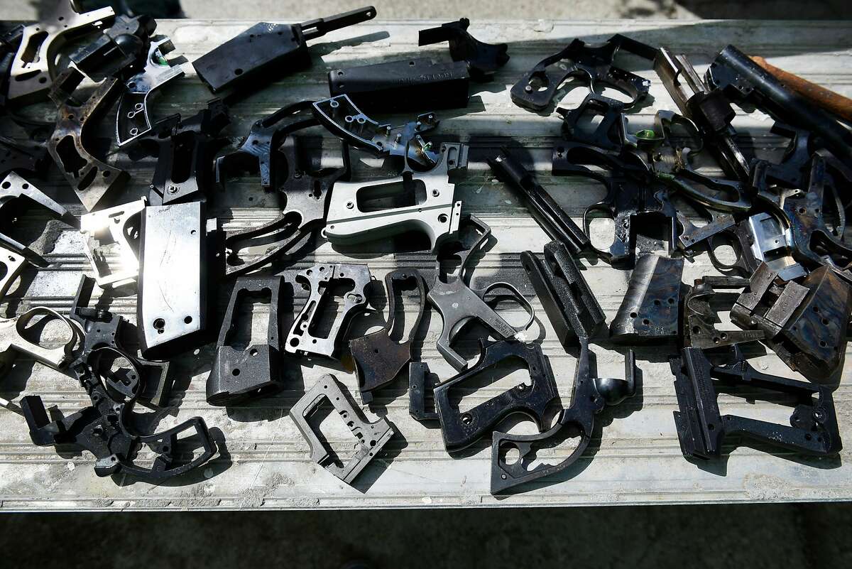 Pieces of disassembled guns sit on a table at American Steel Studios in Oakland, Calif., Saturday April 7th, 2018. The Alameda County District Attorney's Office is partnering with the Robby Poblete Foundation to commission seven sculptures made from disassembled guns.