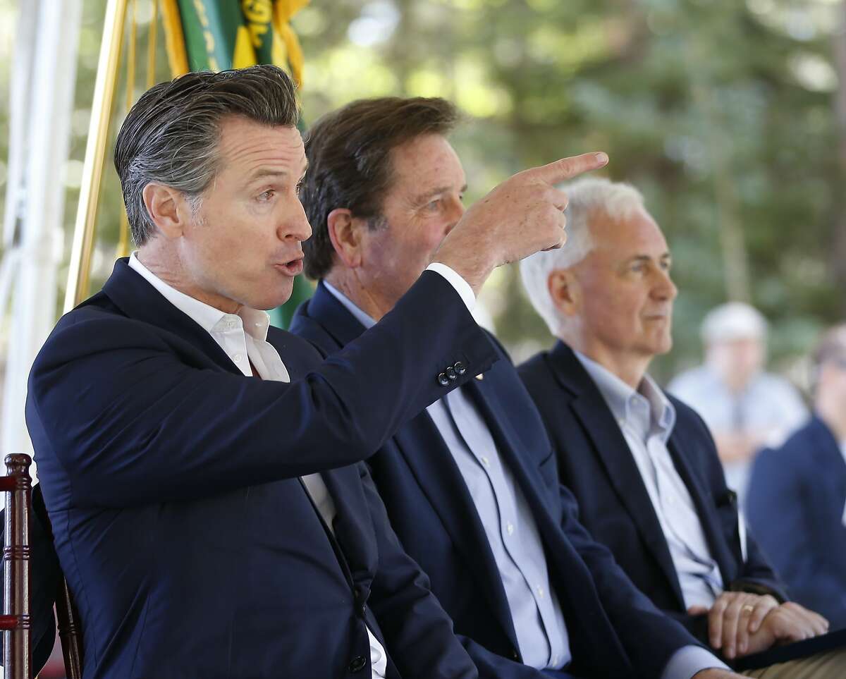 Calif., Gov. Gavin Newsom responds to a group from Butte County calling on him to commit to not accepting campaign money from the Pacific Gas & Electric Co., during the 23rd Annual Lake Tahoe Summit, Tuesday, at South Lake Tahoe, Calif., Tuesday, Aug. 20, 2019. The summit is a gathering of federal, state and local leaders to discuss the restoration and the sustainability of Lake Tahoe. Butte County is where last year's Camp Fire burned through the town of Paradise, killing 86. Newsom met with the group after the summit. (AP Photo/Rich Pedroncelli)