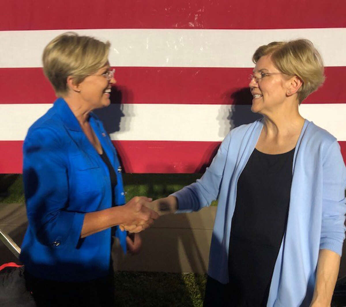 Stephanie Oyen and Sen. Elizabeth Warren, D-Mass., shake hands Monday after a rally at Macalester College in Minnesota.