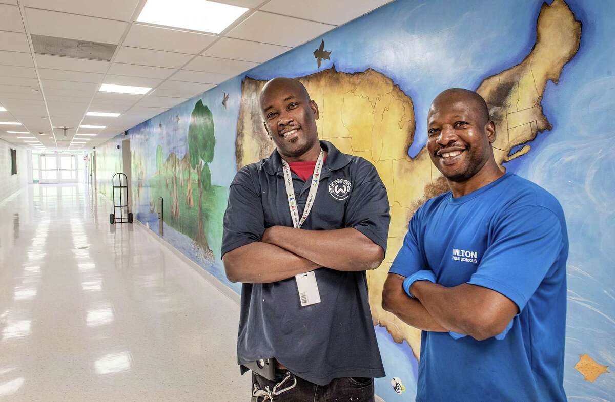 Thol Joseph and Rodney Thoby are preparing Cider Mill School for opening day. Renovations to school include the removal of carpeting and replacing it with tile.