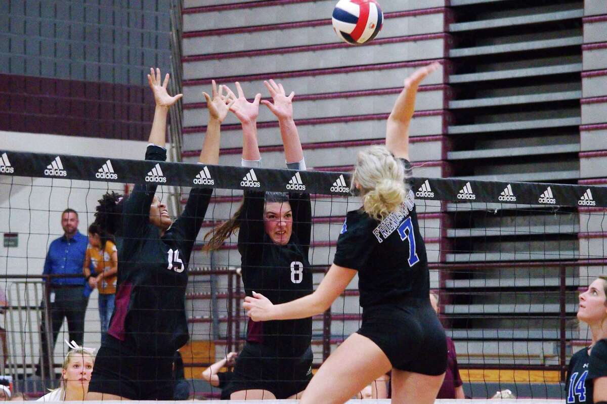 Pearland's April Conant (15) and Reese Cummings (8) try to block a shot by Friendswood's Makensy Manbeck (7) Tuesday at Pearland High School.