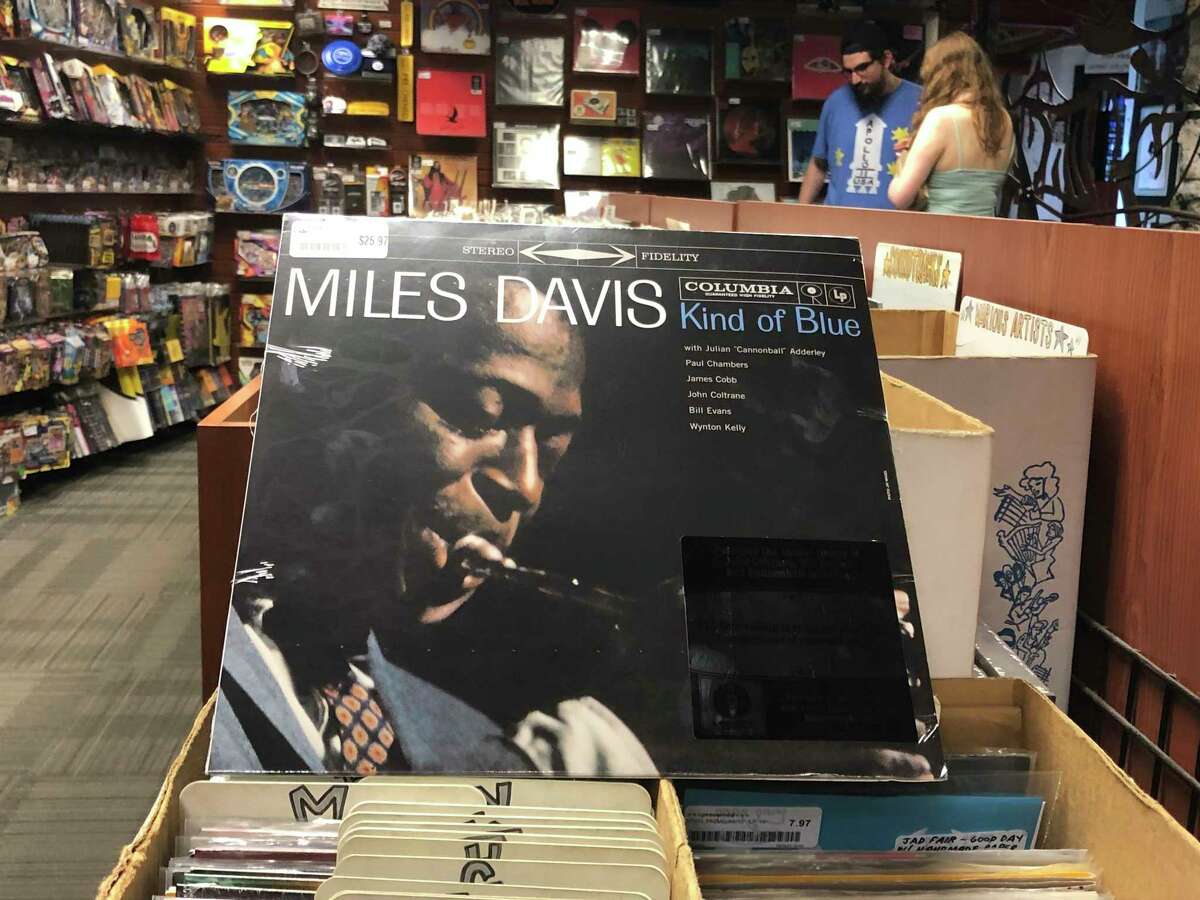 The "Kind of Blue" album cover is on display at Bull Moose record store in Portland, Maine, Saturday, Aug. 17, 2019 on the 60th anniversary of the albumas release. Drummer Jimmy Cobb, the only surviving musician who performed on Miles Davisa jazz masterpiece aKind of Blue,a is still keeping time as the iconic recording marks its 60th anniversary. (AP Photo/David Sharp)