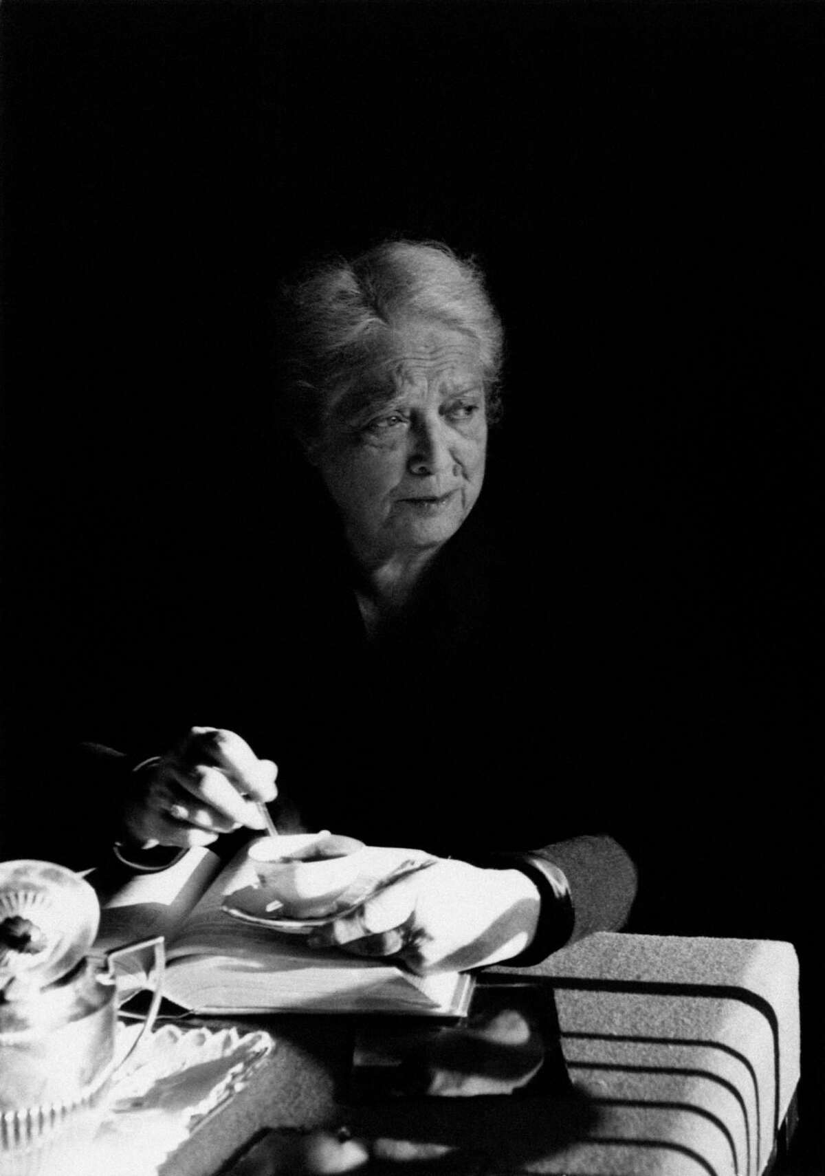 Italian food scholar Ada Boni sits at a table drinking coffee in 1960.