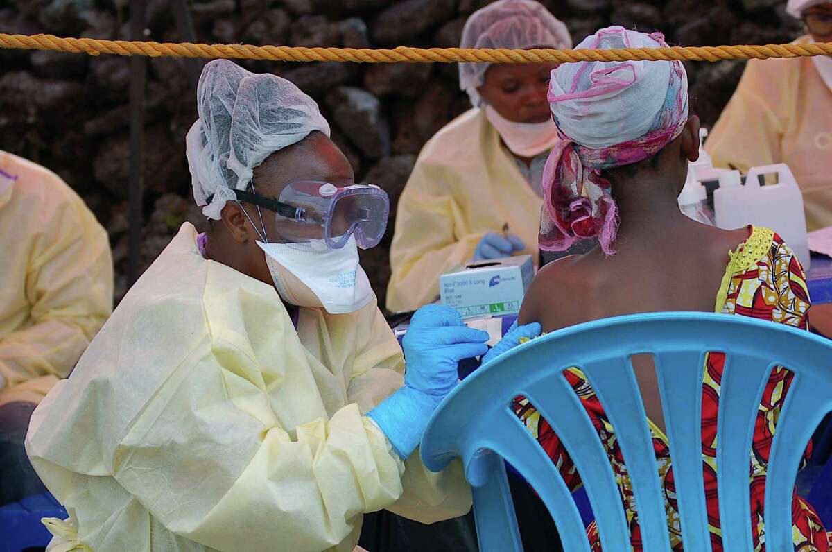 A girl receives a vaccine against Ebola from a nurse in Goma earlier this month. The Congolese presidency said on Aug. 1 that cases of the deadly virus had been detected in the city of 2 million people.