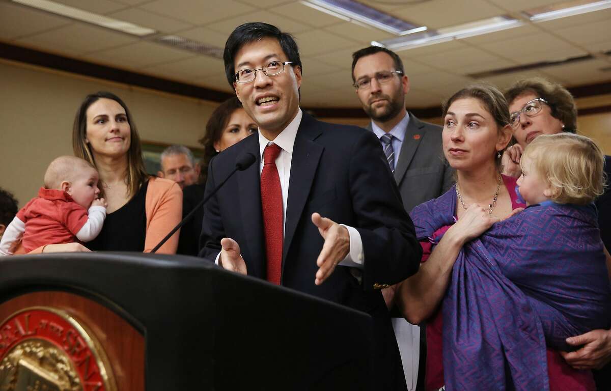 FILE - In this Feb. 4, 2015, file photo, state Sen. Richard Pan, D-Sacramento, center, accompanied co-author Ben Allen, D-Santa Monica, background, and concerned mothers and their children, answers a question about their proposed legislation requiring parents to vaccinate all school children, during a news conference in Sacramento, Calif. California enacted some of the nation's most aggressive social polices this year, including Pan and Allen's SB277 the bill requiring parents to vaccinate school children. (AP Photo/Rich Pedroncelli, File)