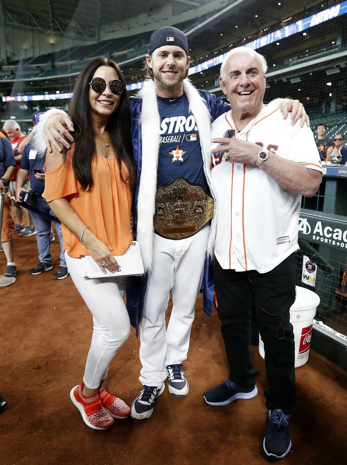 Ric Flair and his wife, Wendy Barlow poses with Houston Astros right fielder Josh Reddick, who came out of the clubhouse wearing his Ric Flair attire during batting practice before the start of an MLB game at Minute Maid Park, Wednesday, August 21, 2019.
