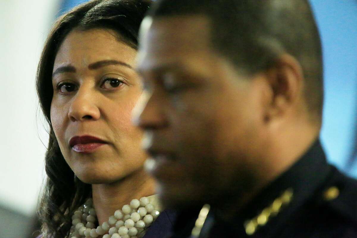 Acting Mayor London Breed (l to r) listens to Police Chief Bill Scott speak during a gun buy-back press conference at United Playaz on Wednesday, December 13, 2017 in San Francisco, Calif.