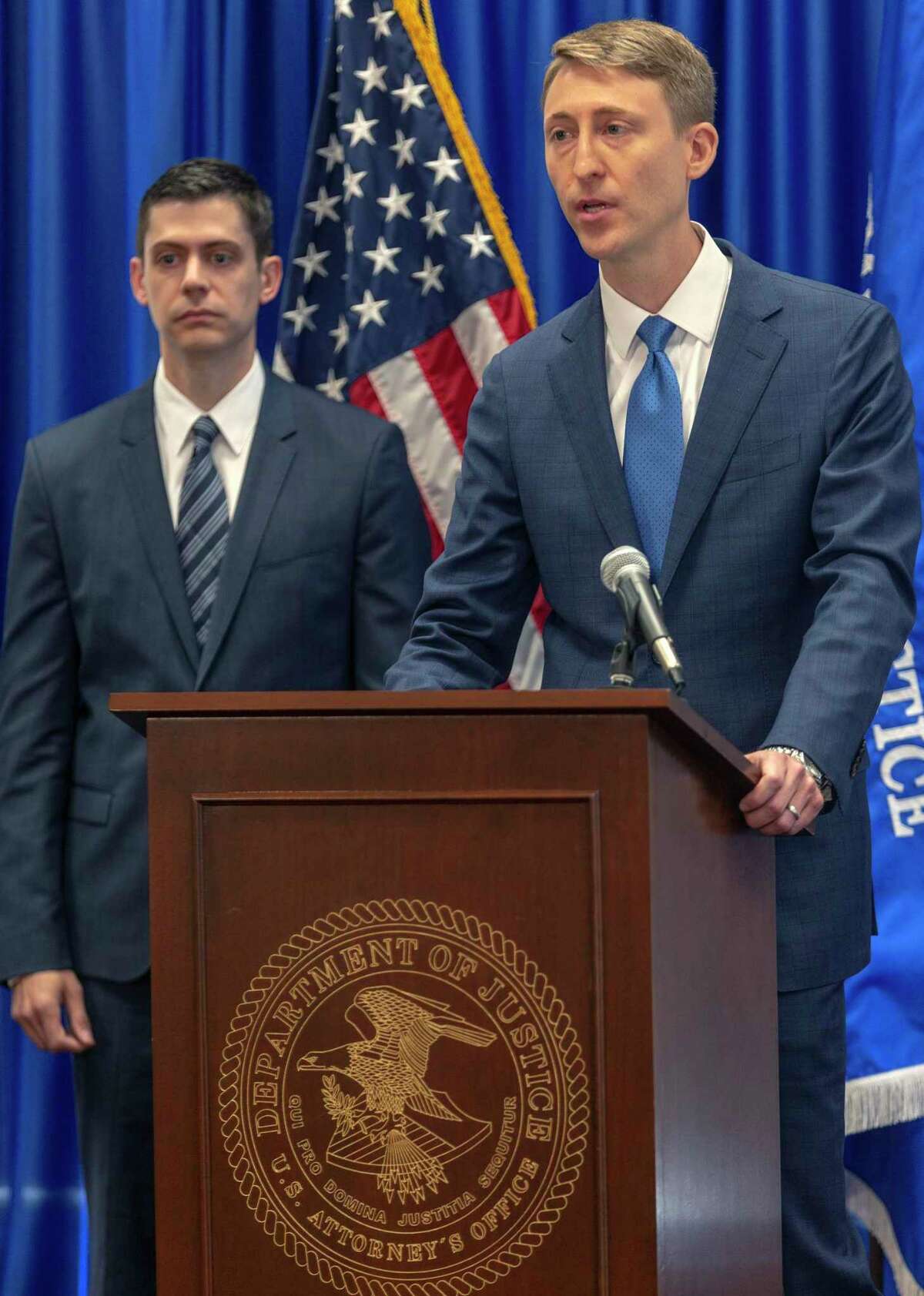 Gus Eyler, right, Director of the Department of Justice Consumer Protection Branch speaks Wednesday, Aug. 21, 2019 about the arrest of five people for allegedly stealing millions of dollars from elderly and disabled veterans in a scheme that used stolen identity information to access Department of Defense and Veteran Affairs benefit websites. John F. Bash, left, U.S. Attorney for the Western District of Texas, also spoke during the press conference.