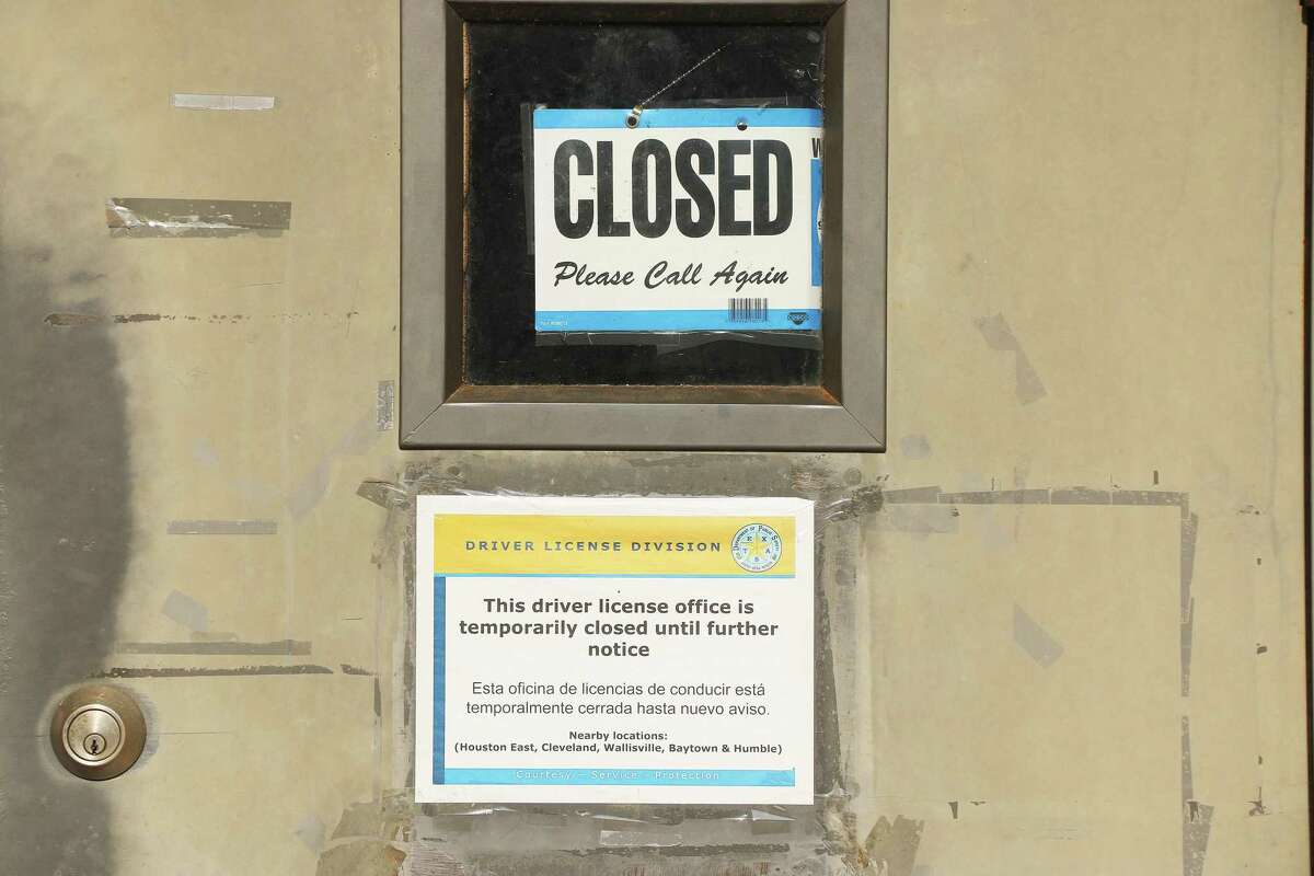 A clearly vacant DPS office has a closed sign and a note on the door explaining the office is closed but only temporarily. The office was closed down to train more staff and it will take about four months.