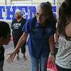 South San Antonio Independent School Board of Trustees President Connie Prado greets students for the first day of classes at the newly reopened Athens Elementary School, Aug. 19.