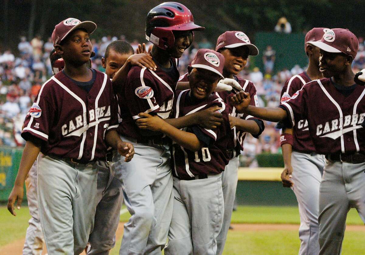 Willemstad, Curacao, Netherlands Antilles' Jurickson Profar is congratulated by teamates after hitting a two run blast during the first inning against Thousnd Oaks, California, at the Little League World Series Championship in Williamsport, PA, on Sunday.