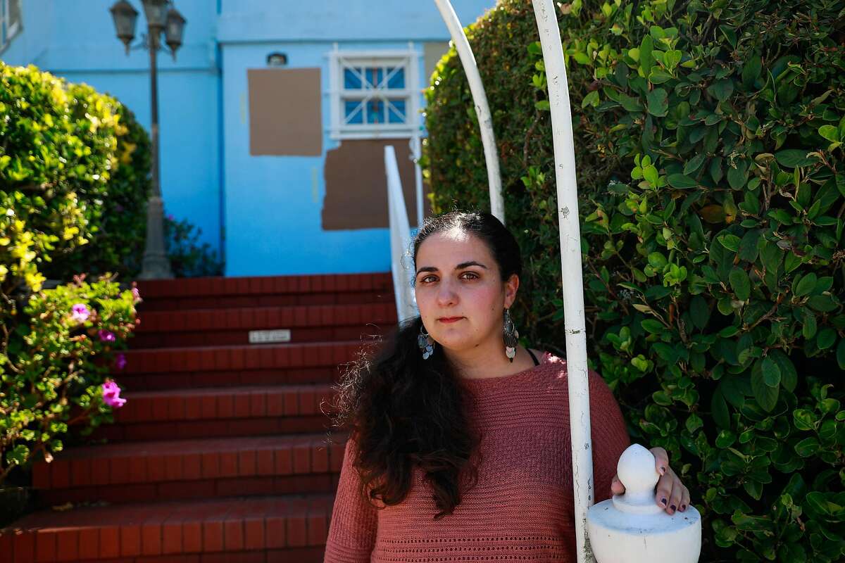 Anna Chase poses for a portrait outside of the house that she was recently evicted from in Monterey Heights in San Francisco, California, on Wednesday, Aug. 21, 2019. She rented a room through HubHaus, a startup that facilitates "co-living communities".