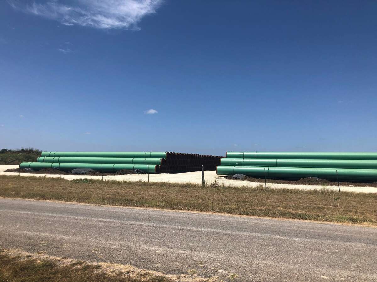 Pipe for the Permian Highway natural gas pipeline, a collaboration between Kinder Morgan, EagleClaw Midstream and Apache, sits in yards ready for construction to begin. A centerline stake sits along the pipeline’s route.