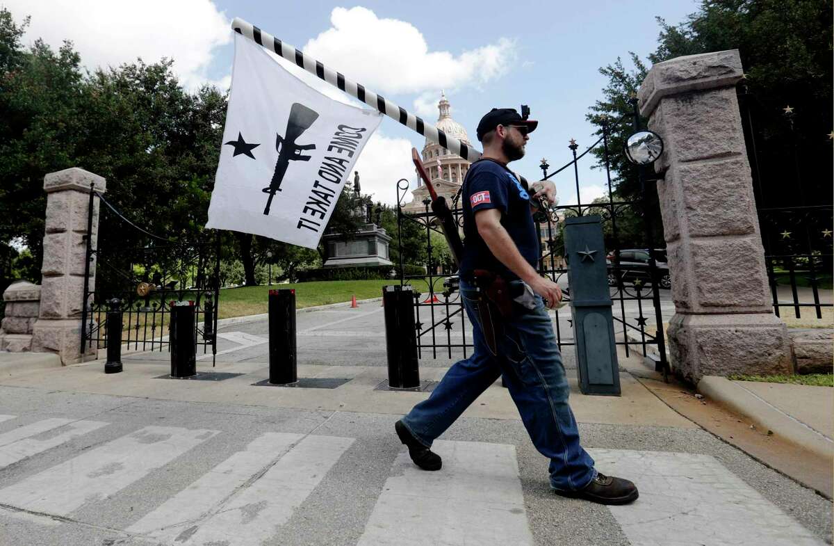 Gun rights advocates gather outside the Texas Capitol where Texas Gov. Greg Abbott held a round table discussion, Thursday, Aug. 22, 2019, in Austin, Texas. Abbott is meeting in Austin with officials from Google, Twitter and Facebook as well as officials from the FBI and state lawmakers to discuss ways of combatting extremism in light of the recent mass shooting in El Paso that reportedly targeted Mexicans. (AP Photo/Eric Gay)