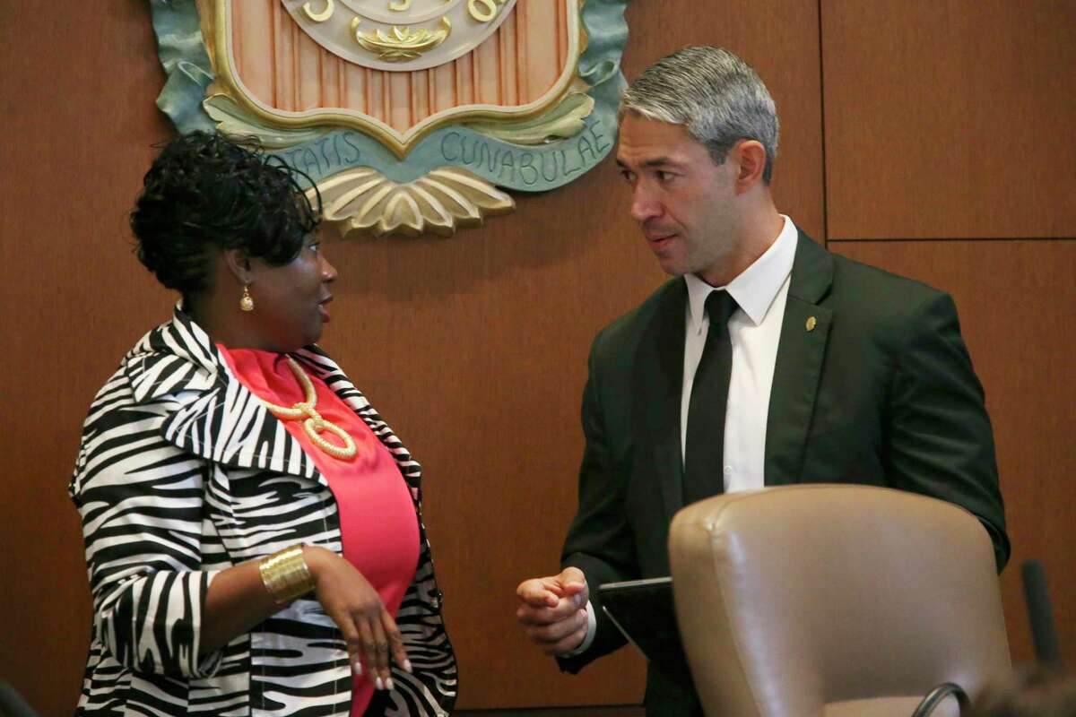 District 2 Councilwoman Jada Andrews-Sullivan, left, talks with Mayor Ron Nirenberg before a council meeting last week. Andrews-Sullivan and fellow Councilman John Courage are proposing a citywide gun buy-back program to help reduce gun violence in the wake of recent mass shootings.