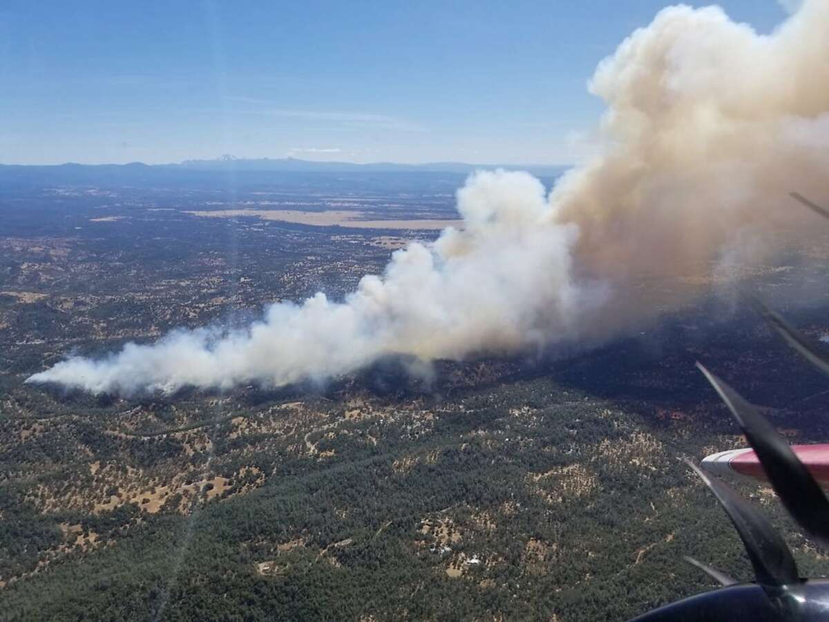 This photo provided by Cal Fire shows an aerial view of the Mountain Fire burning Thursday, Aug. 22, 2019, near Redding, Calif. A fast-moving Northern California wildfire is threatening thousands of homes and forcing evacuations. The fire in Shasta County started around noon in a rural area northwest of Redding about 200 miles (320 kilometers) north of San Francisco. CalFire Capt. Robert Foxworthy says the blaze quickly spread to more than 600 acres, or about one square mile. Foxworthy says about 2,000 structures may be threatened, though officials haven't conducted a thorough count yet. (Cal Fire via AP)