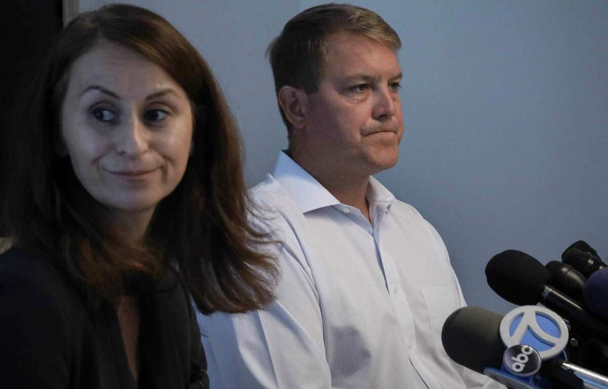 Scott Hapgood, right, a U.S. financial adviser charged with killing a hotel worker while on vacation in Anguilla, and his lawyer Juliya Arbisman, left, hold a press conference, Tuesday Aug. 20, 2019, in New York. The case has sparked racial tensions on the Caribbean island that caters to wealthy tourists, and some Anguillans are demanding that Hapgood return to face justice in the British territory of nearly 15,000 people. (AP Photo/Bebeto Matthews)