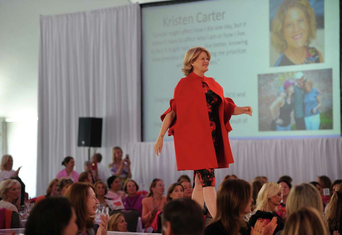 Breast cancer survivor Kristen Carter takes her turn on the catwalk during the Breast Cancer Alliance Annual Luncheon and Fashion Show at the Hyatt Regency Hotel in Greenwich, Conn. on Tuesday, October 30, 2018.