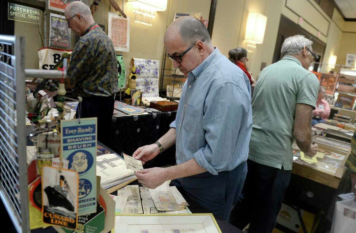 Michael Russo of Guilford looks at letter envelopes with hand-drawn cartoons at the Ephemera Fair at the Greenwich Hyatt Regency Hotel on Saturday, March 16, 2019.