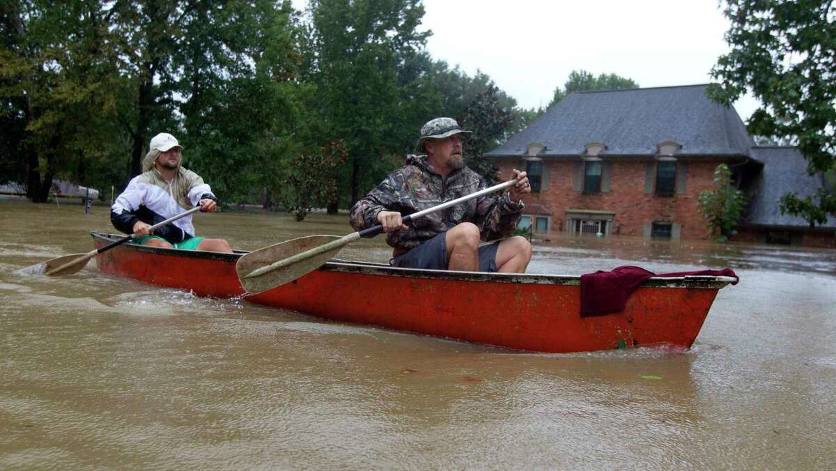 Montgomery County is continuing its home buyout program and is seeking federal dollars to help move that effort forward. In this file photo, Josh and Levi Curnel paddle down Stonewall Jackson Drive past flooded homes during Hurricane Harvey.