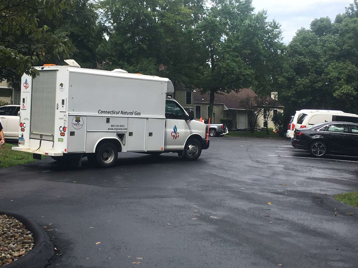 Work crews from Connecticut Natural Gas restore service at Greenwich Oaks off Weaver Street Friday morning.