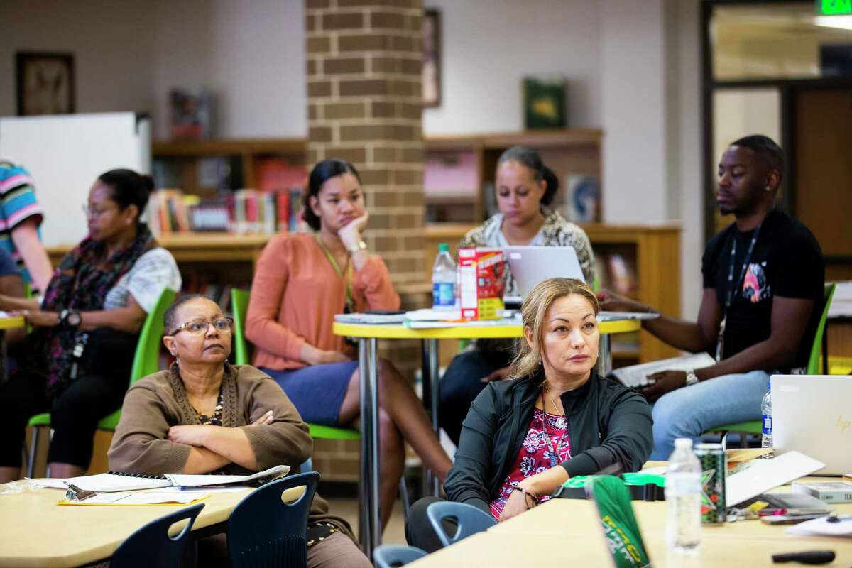 Worthing High School teachers and staff gather in the school’s library on Thursday, Aug. 22, 2019, in Houston to go over new plans for the school year.