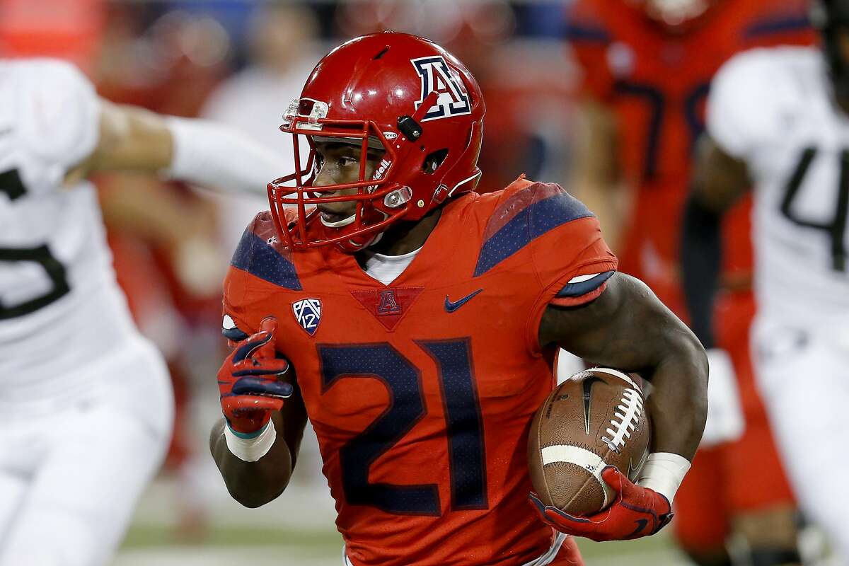 Arizona running back J.J. Taylor (21) runs during an NCAA college football game against Oregon, Saturday, Oct. 27, 2018, in Tucson, Ariz. Arizona is looking for more consistency after a disappointing first season under coach Kevin Sumlin. The Wildcats return several key players, led by quarterback Khalil Tate and running back J.J. Taylor. Arizona opens its season playing at Hawaii on Aug. 24. (AP Photo/Rick Scuteri)