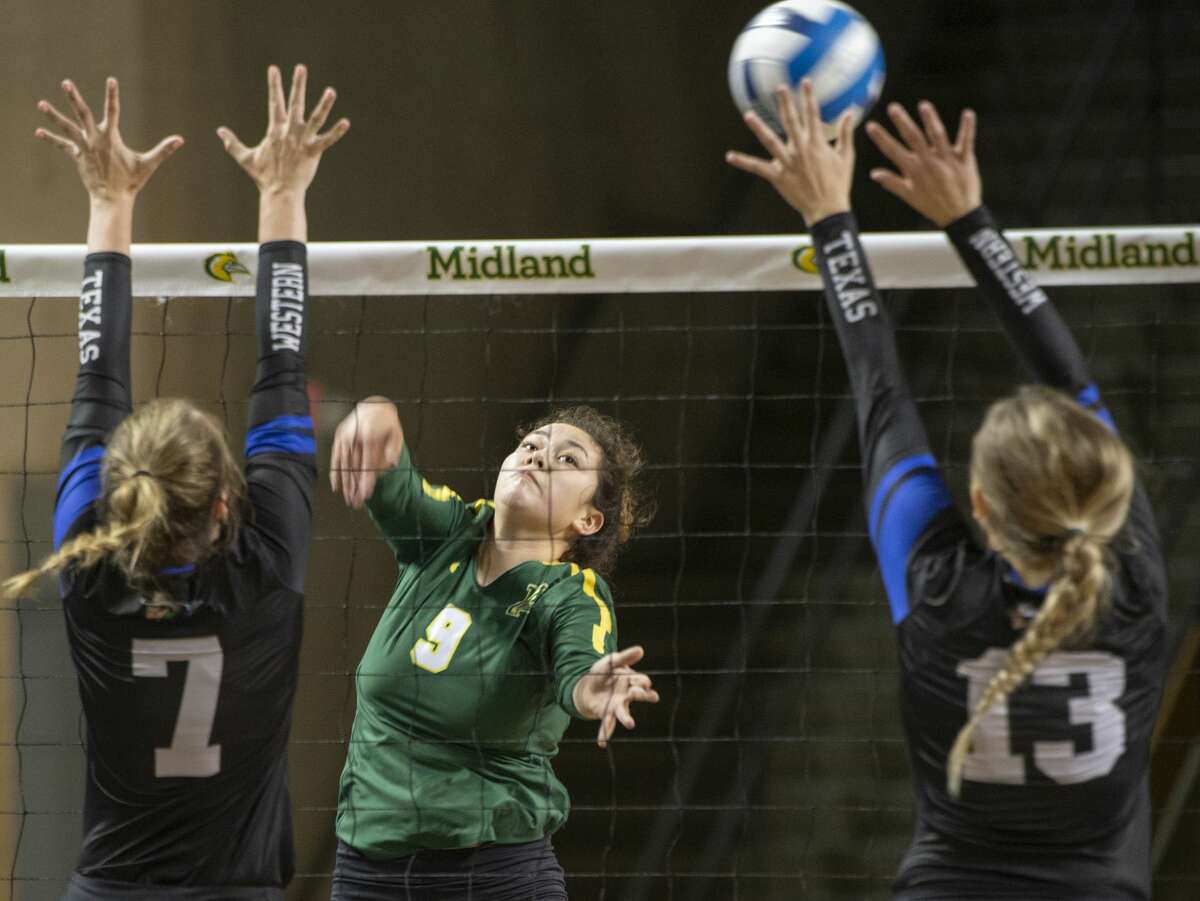 Midland College's Lesly Galarza tries to hit the ball between Western Texas College's Mackensi Christian and Landry Oliver 08/24/19 in the Midland College Kickoff Classic at the Chaparral Center. Tim Fischer/Reporter-Telegram