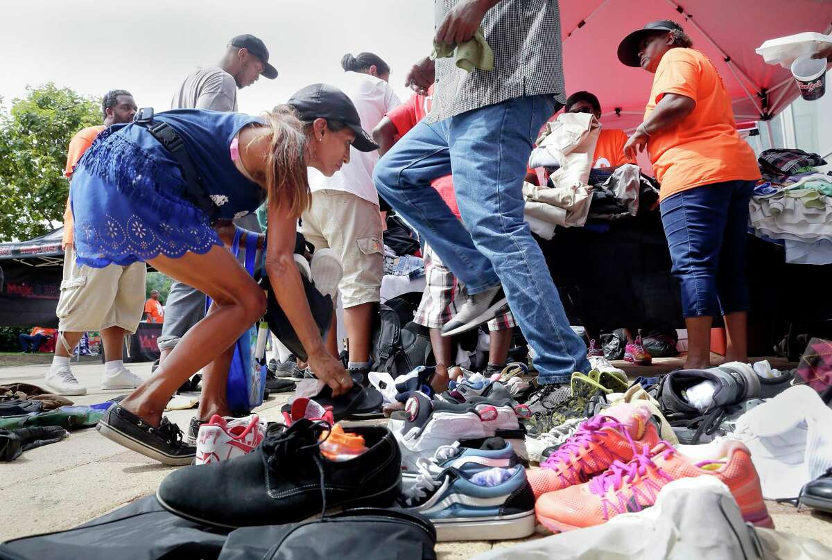 Attendees sort through free shoes and clothing during the second Hope for Homeless block party, put on by Overflow Church, at Discovery Green Saturday, Aug. 24, 2019 in Houston, TX. The event is an annual day of action where volunteers come together to draw attention to homelessness in the City Of Houston.