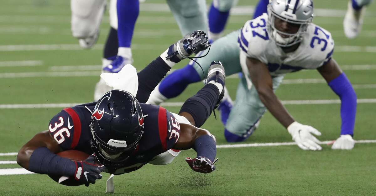 Houston Texans running back Damarea Crockett (36) is tripped up by Dallas Cowboys defensive back Donovan Wilson (37) during the second quarter of an NFL preseason football game at AT&T Stadium on Saturday, Aug. 24, 2019, in Arlington, Texas.