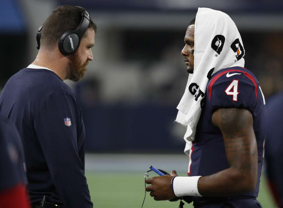 Houston Texans offensive coordinator Tim Kelly, left, talks to quarterback Deshaun Watson (4) during the second quarter of an NFL preseason football game against the Dallas Cowboys at AT&T Stadium on Saturday, Aug. 24, 2019, in Arlington, Texas.
