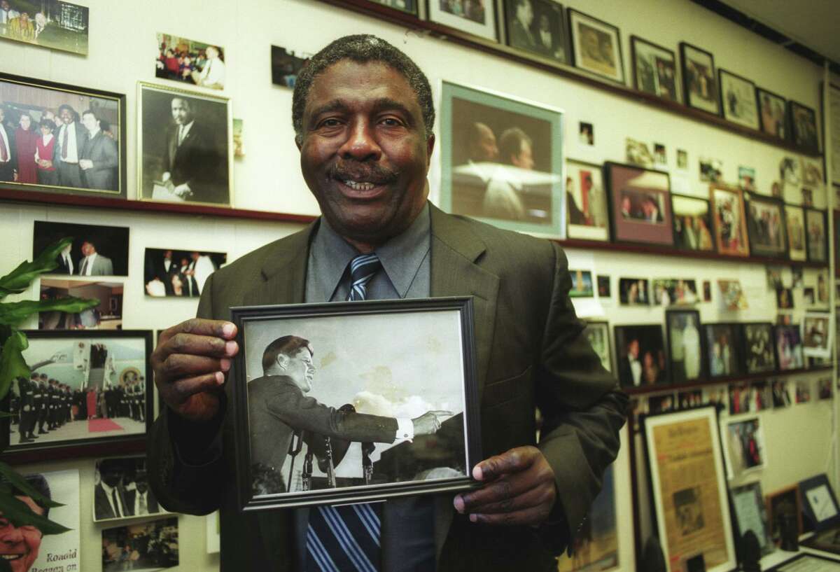 FILE PHOTO - / 11/7/03 Charles Tisdale holds a photo of John F. Kennedy at his office at ABCD in Bridgeport Nov. 7. Tisdale got the photo from Joe Kennedy in 1978 after seeing the picture in the Kennedy home and mentioning he liked it, so they gave it to him.