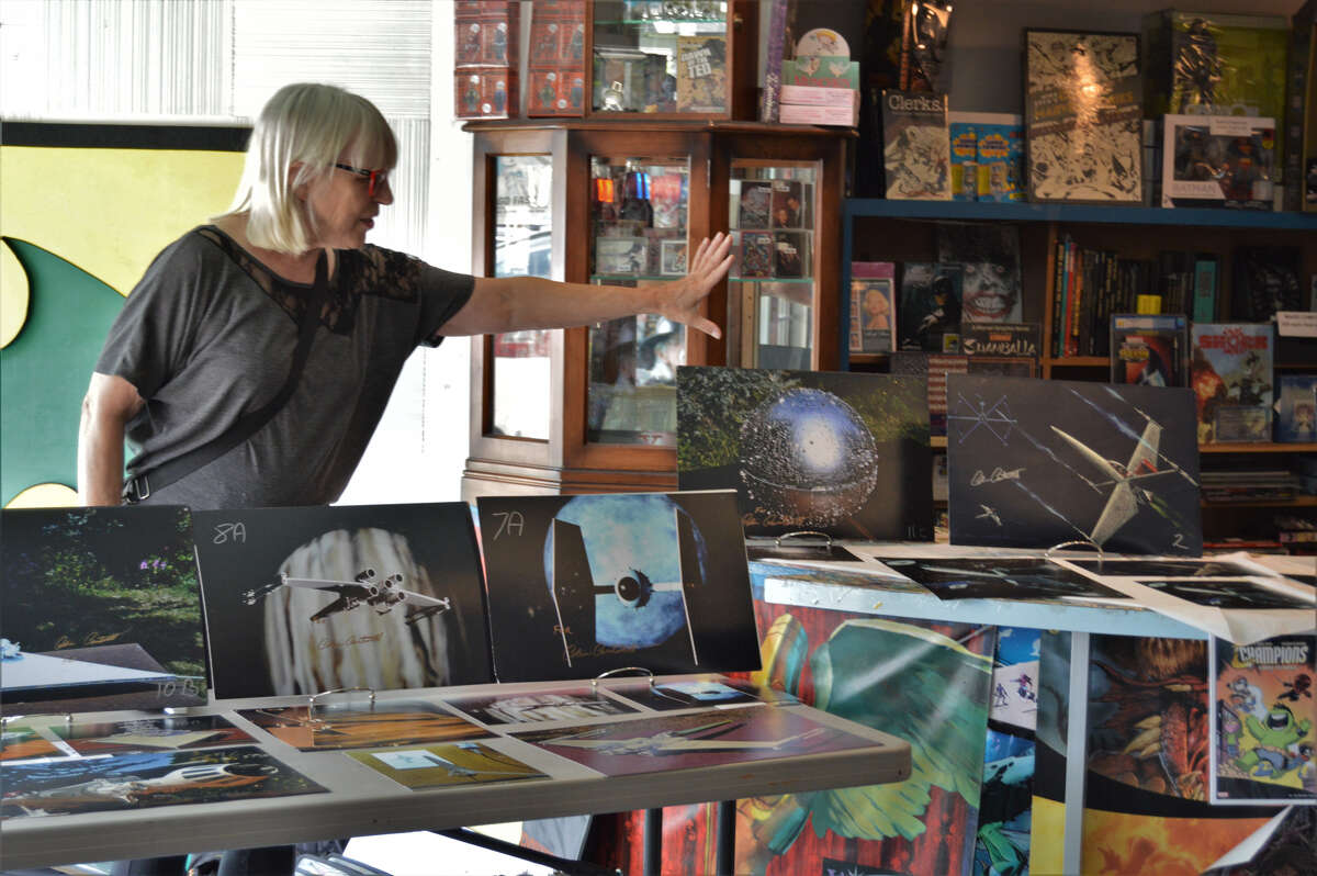 Colin Cantwell, one of the original design artists for the 1977 movie "Star Wars: Episode IV - A New Hope," visited a Midland comic shop, Collector's Corner on Saturday, Aug. 24, 2019. Cantwell's partner of 25 years, Sierra Dall introduces his work to the audience. (Ashley Schafer/Ashley.Schafer@hearstnp.com)