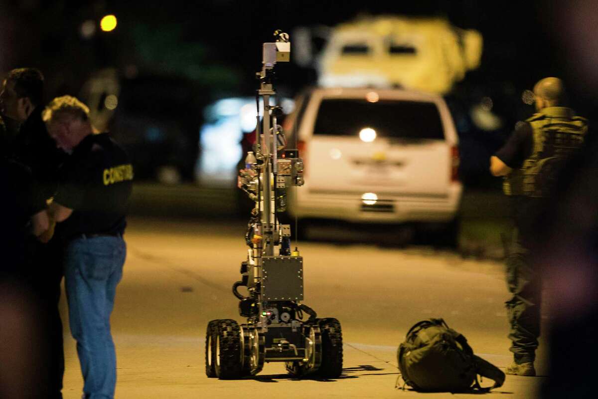 Law enforcement officers deploy a robot during a standoff with a shooting suspect on Wednesday, July 9, 2014, in Spring. The suspect is believed to have shot seven people, with a number of fatalities reported.