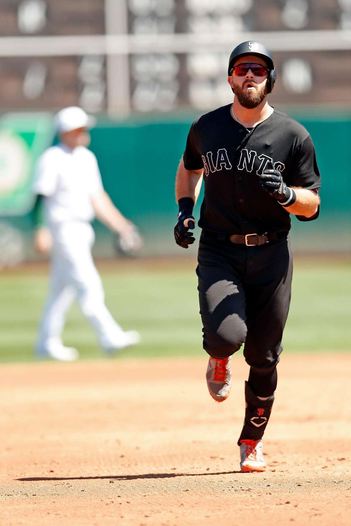 San Francisco Giants' Evan Longoria rounds the bases after solo home run in 3rd inning during MLB game at Oakland Coliseum in Oakland, Calif., on Sunday, August 25, 2019.