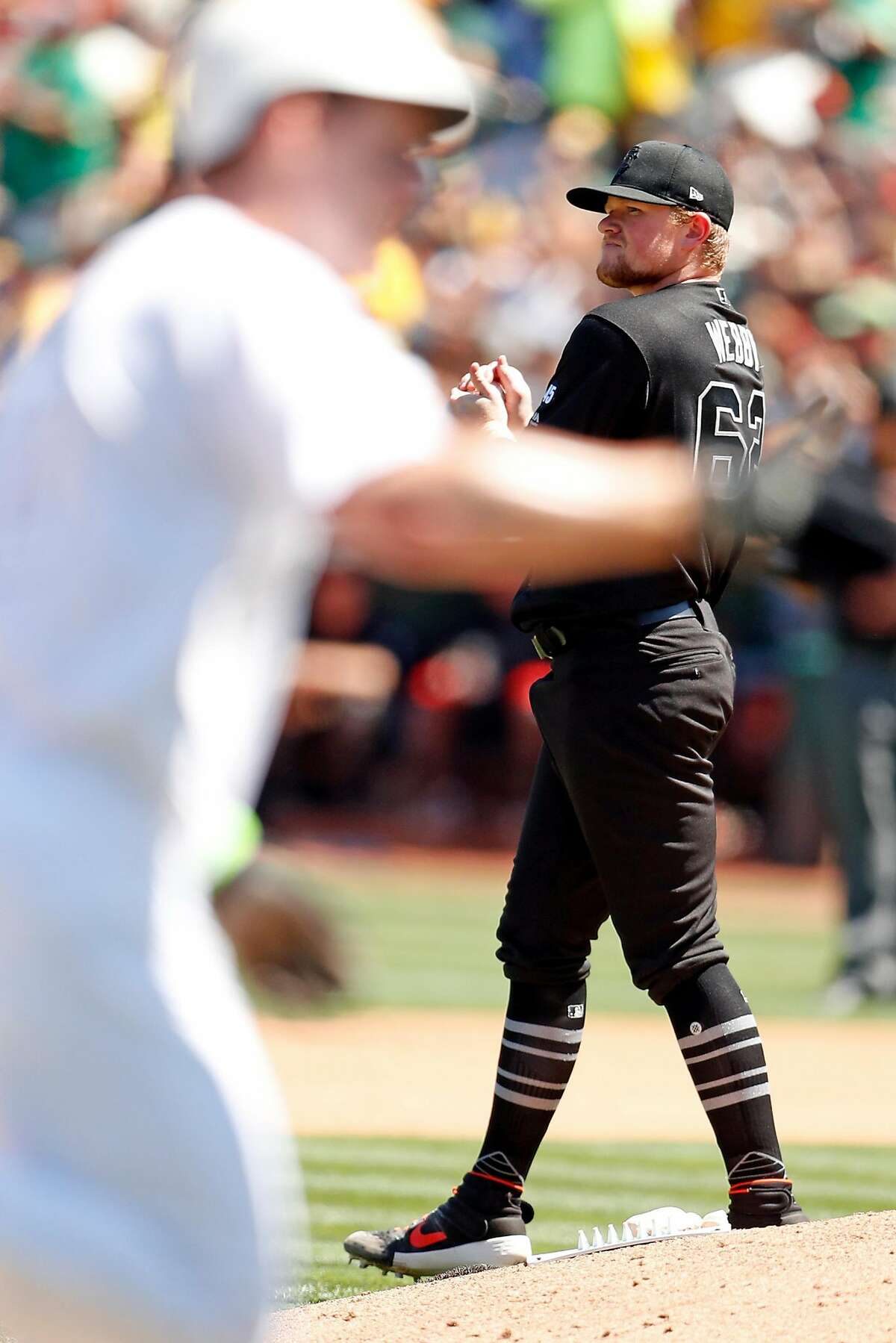 San Francisco Giants' starting pitcher Logan Webb looks away in the 4th inning as Oakland Athletics' Mark Canha rounds the bases after his second solo home run of the game during MLB game at Oakland Coliseum in Oakland, Calif., on Sunday, August 25, 2019.