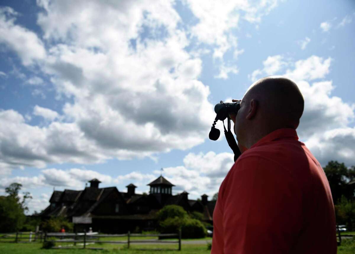 Jason Grippo, of Rye Brook, N.Y., watches hawks through binoculars. The Greenwich Audubon Center will hold its 21st annual Fall Festival & Hawk Watch from 12:30 to 5:30 p.m. Sunday to celebrate the fall migration season. There will be raptor shows, wildlife releases, games, crafts, hayrides, rock climbing wall, food trucks, music and more. The event coincides with the migration season for the thousands of raptors that pass over the center. Admission is $10 formembers, $15 for nonmembers, and children 2 and under are free. For details and to register, visit greenwich.audubon.org/fall-festival-and-hawk-watch.