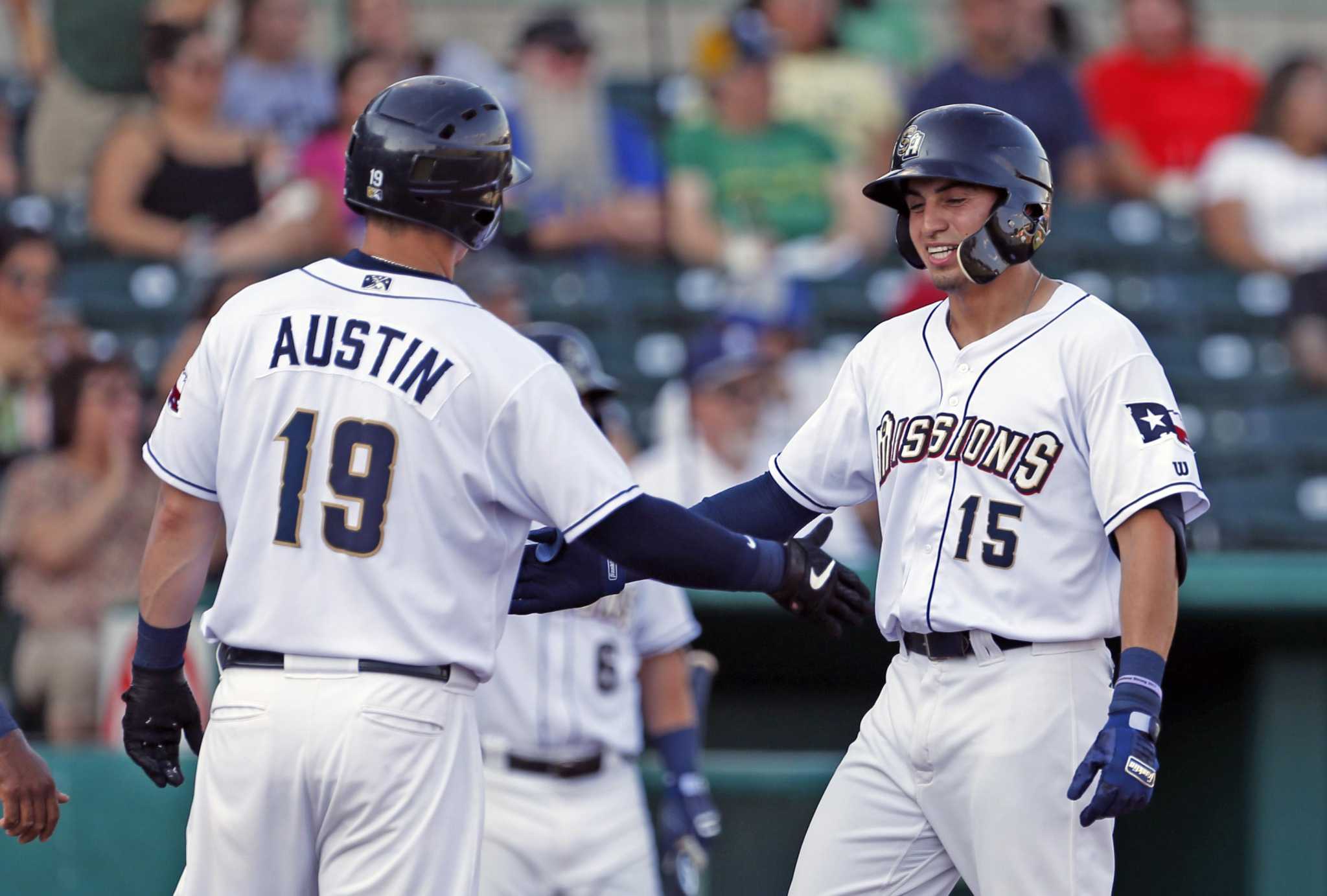 Milwaukee Brewers' Tyrone Taylor celebrates with Keston Hiura