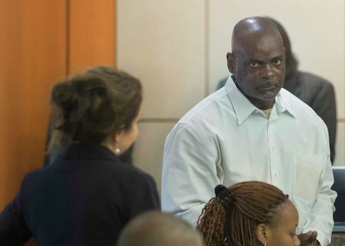 Former Houston Police Department narcotics officer Gerald Goines talks to his defense attorney Nicole DeBorde while appearing before Harris County Judge Frank Aguilar on Monday, Aug. 26, 2019, in Houston. Goines is charged with felony murder in deaths of Dennis Tuttle and Rhogena Nicholas in a botched drug raid in January.