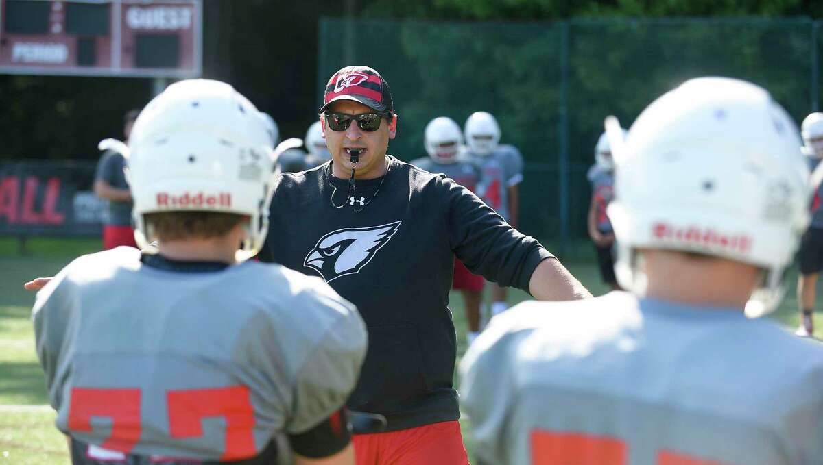 New Greenwich football head coach Anthony Morello works with the team during the first practice of the season on Monday in Greenwich. The Cardinals went 13-0 last season and won the Class LL state title.