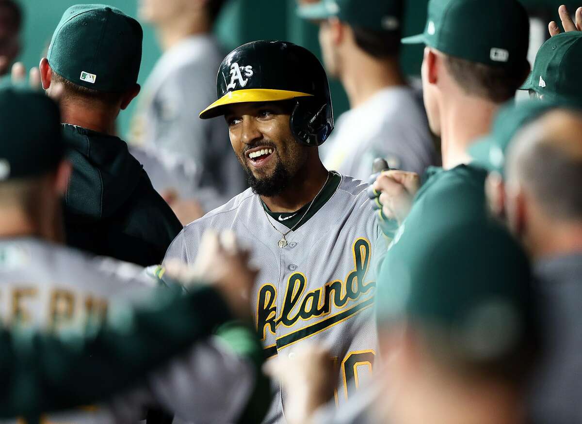 KANSAS CITY, MISSOURI - AUGUST 26: Marcus Semien #10 of the Oakland Athletics is congratulated by teammates in the dugout after hitting a three-run home run during the 3rd inning of the game against the Kansas City Royals at Kauffman Stadium on August 26, 2019 in Kansas City, Missouri. (Photo by Jamie Squire/Getty Images)